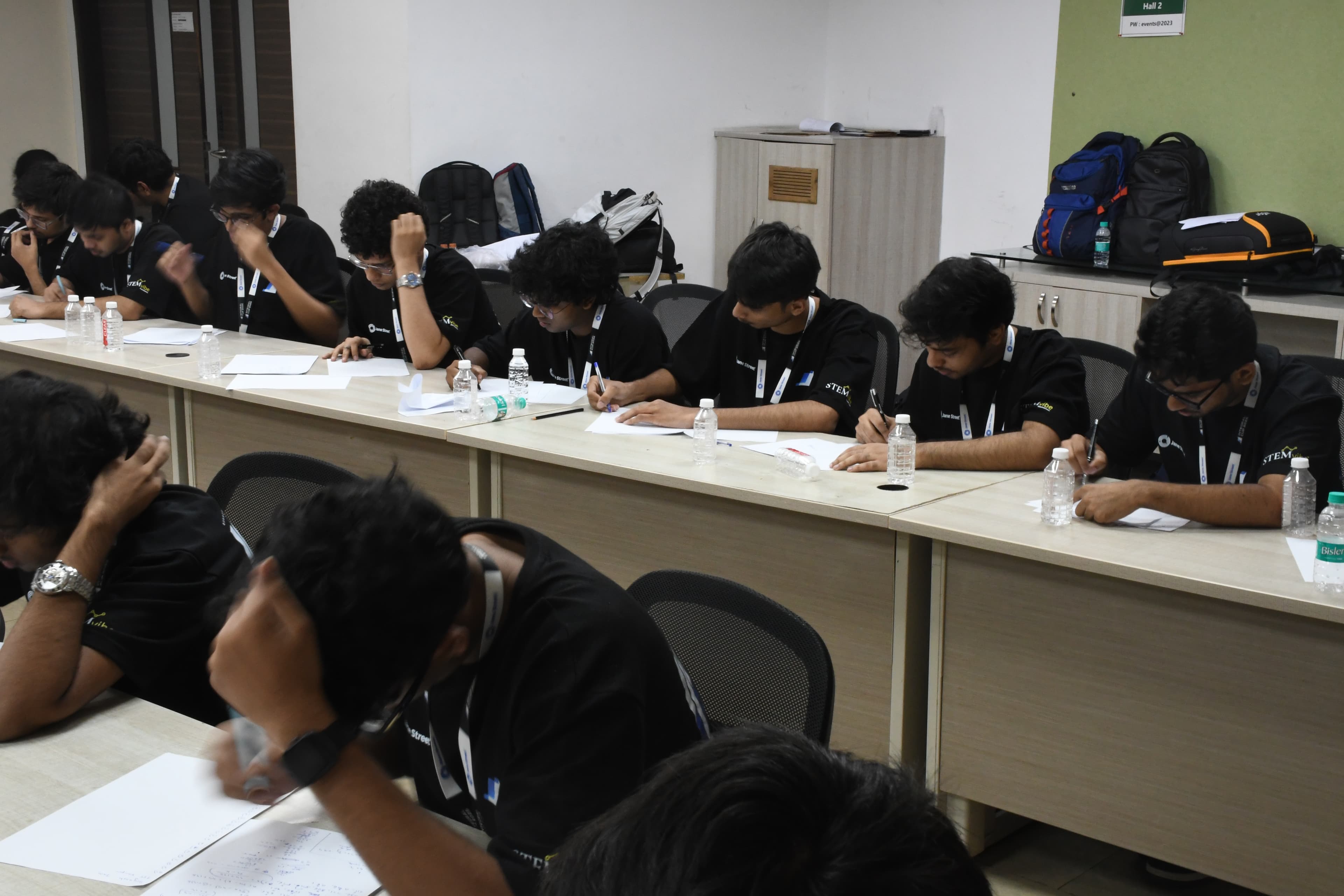 Finalists solving problems around tables during the competition at IIT Madras